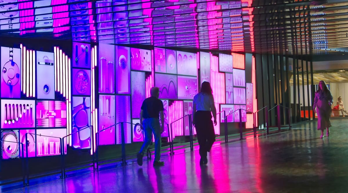 A large, modern exhibition hall arranged with exhibitor stands and clear visitor walkways.