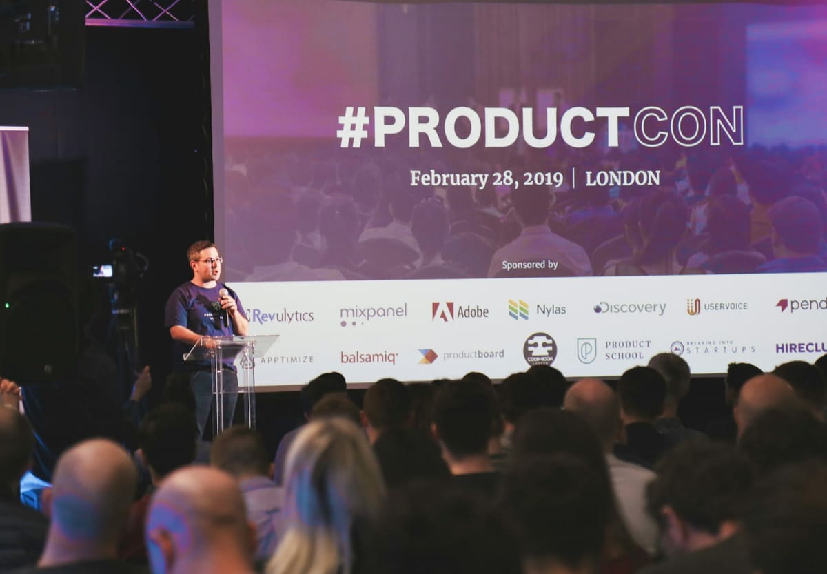 A product presentation taking place on a stage at a brand event.